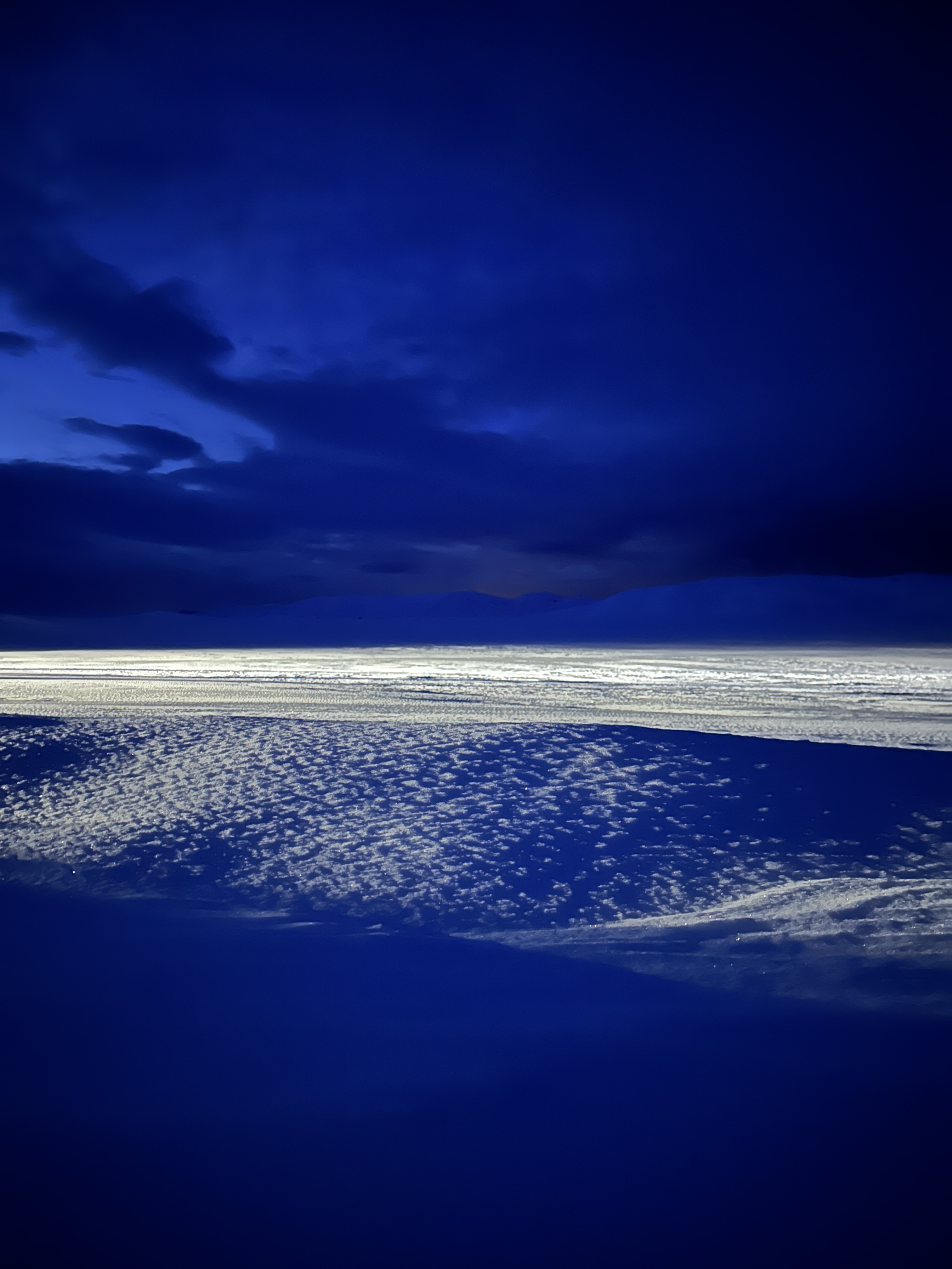 Snow field under deep blue winter clouds.