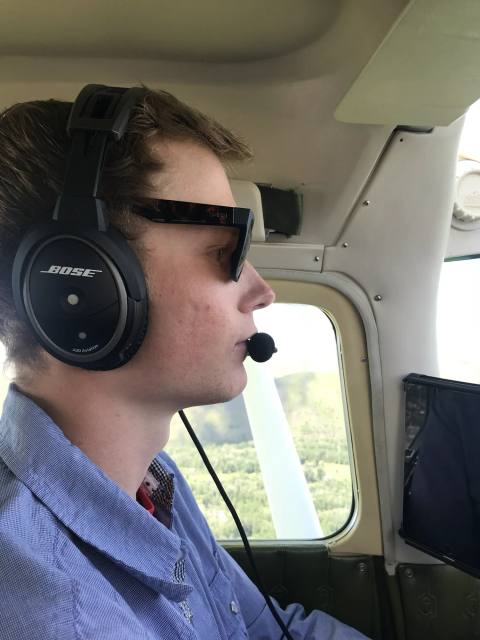 Aircraft passenger wearing a headset during the Craters survey flight