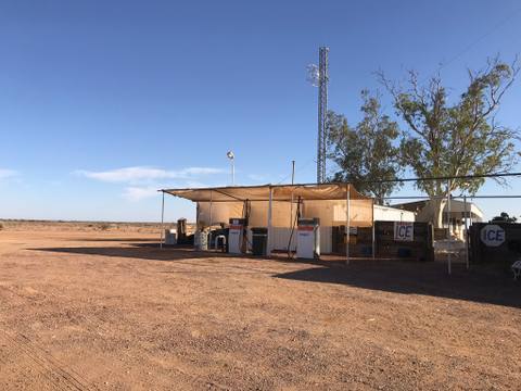Remote outback fuel stop beneath a clear blue sky