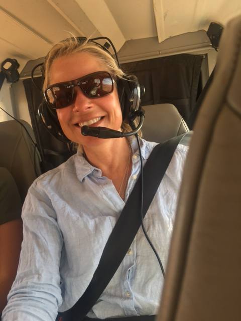 Lisa Wood wearing a headset during the Simpson Desert survey flight
