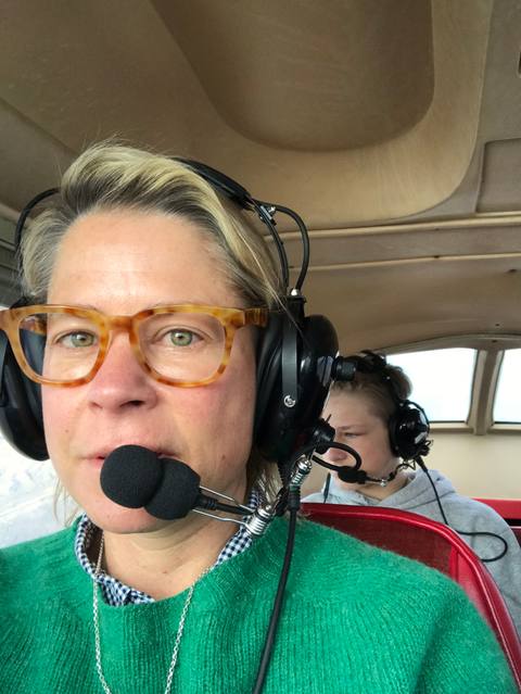 Lisa Wood wearing a headset inside a survey aircraft