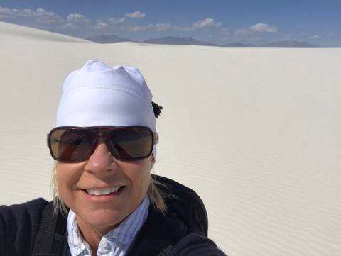 Lisa Wood taking a self-portrait among the white gypsum dunes
