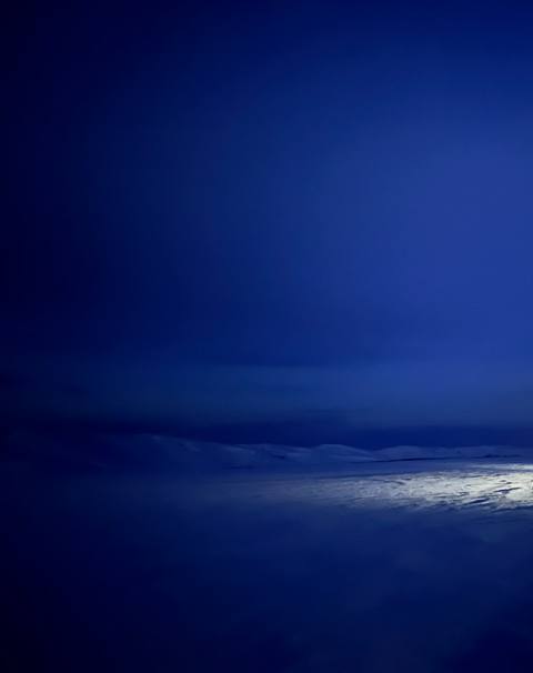 Dark blue sky and snowy prairie before dawn